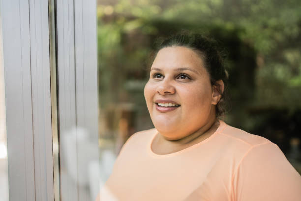 contemplative mid adult woman looking through window