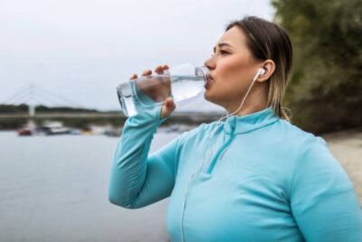 young overweight chubby woman after running taking a break